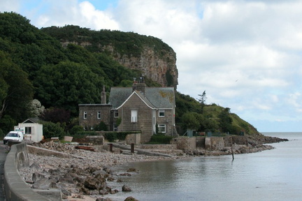 House beneath cliff