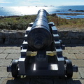 Cannon pointing at lighthouse