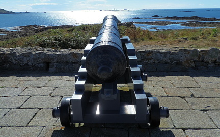 Cannon pointing at lighthouse