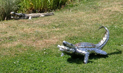 Metal crocodiles by the lake