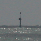 Some sort of pole out at sea