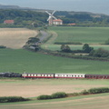 Steam train in front of windmill