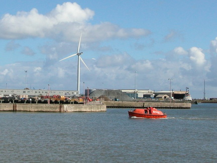 Boat in front of turbine